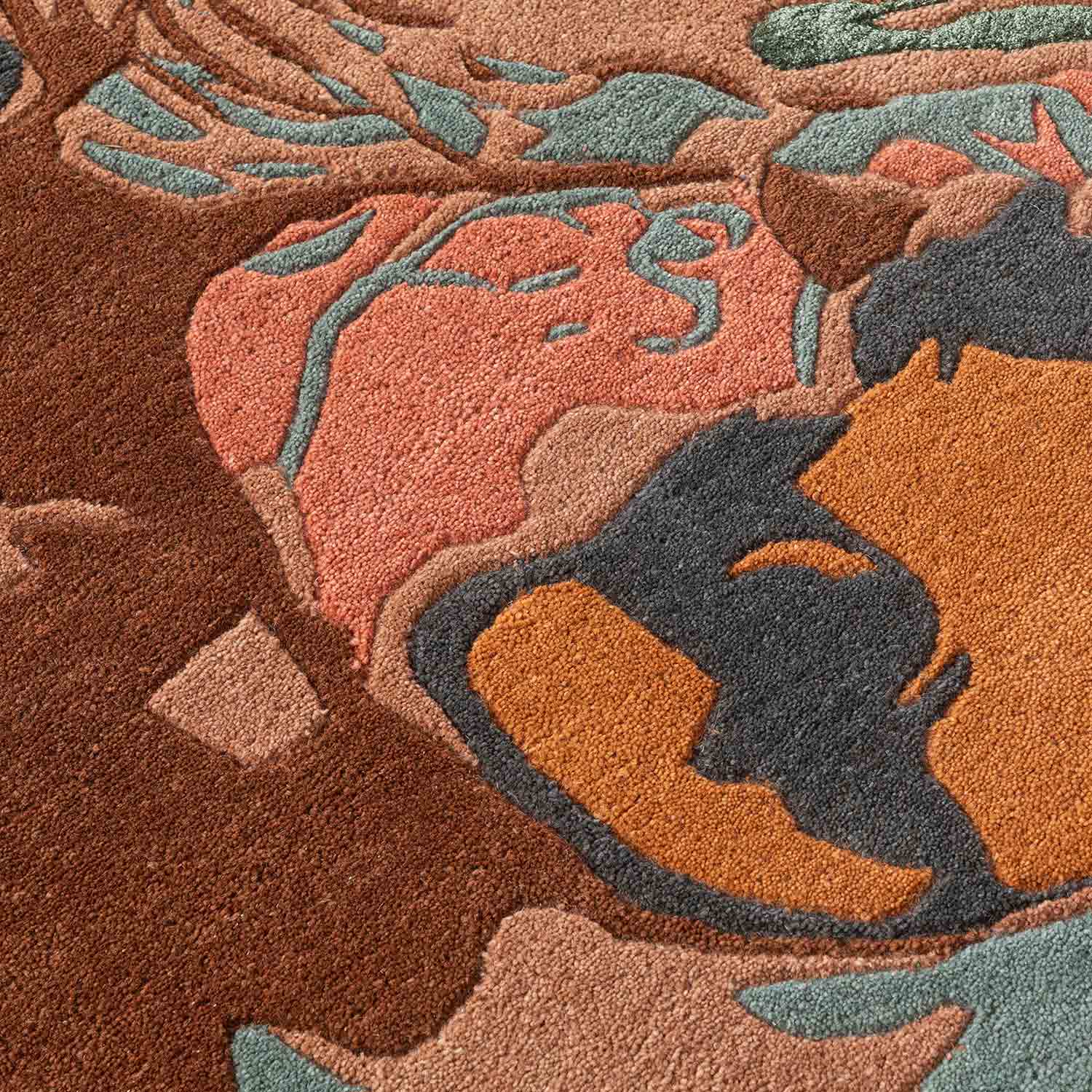 Close-up of a textured rug with abstract leaf patterns in earthy tones.