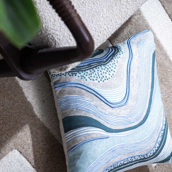 Waves and Whorls cushion cover by Obeetee - styled view
