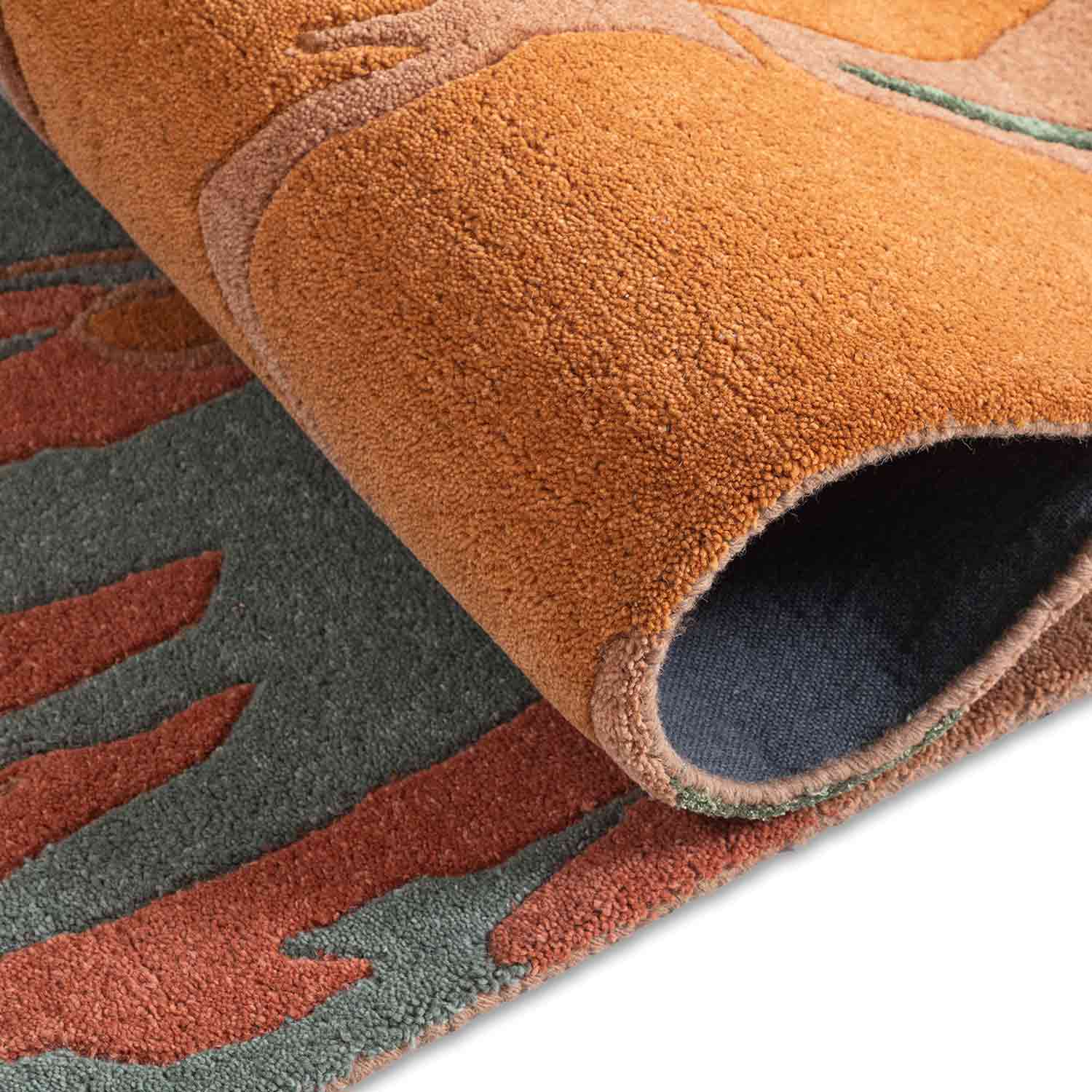 Close-up of a textured rug with brown, red, and gray colors.